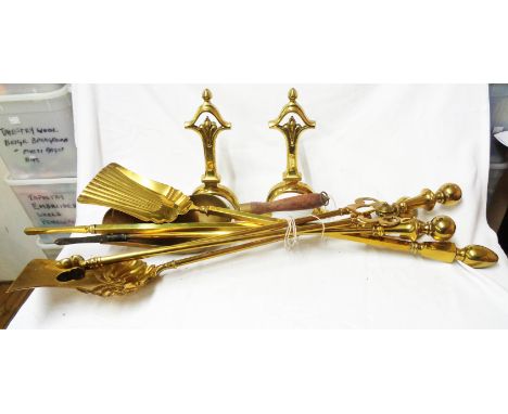 A selection of brass long handle fire tools and a pair of brass fire dogs