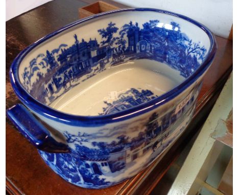 A small modern blue and white ceramic footbath