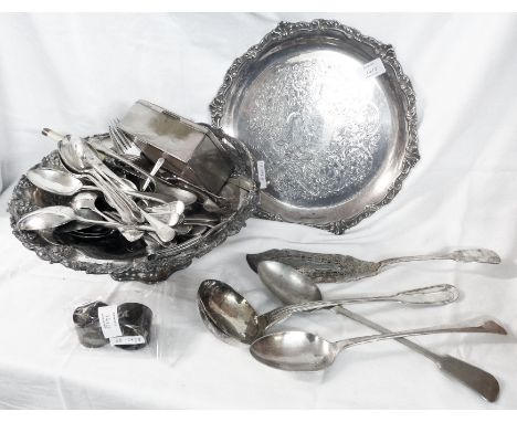 A silver plated cake basket containing a quantity of assorted cutlery, including two basting spoons and large ladle, also a p