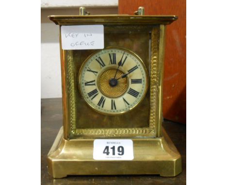 A late 19th Century brass and glazed case carriage style alarm clock with American musical movement