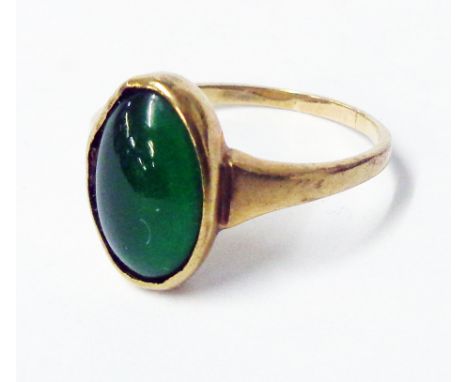 An unmarked yellow metal jade cabochon ring - boxed
