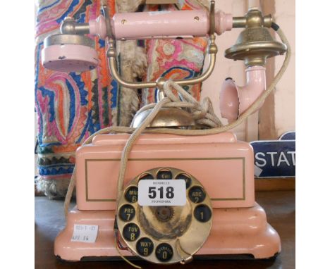 A vintage pink telephone in the antique style