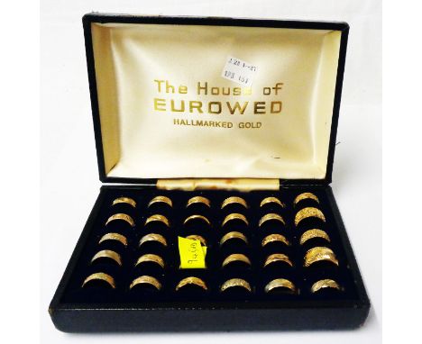 A vintage Euroweb cased travelling display set of gilt metal wedding bands - also included one 9ct. gold example