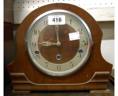 A mid 20th Century walnut cased mantel clock with eight day chiming movement