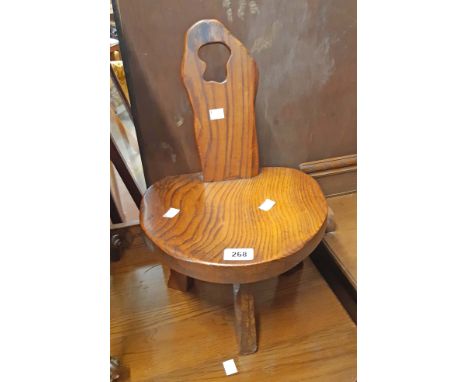 A vintage stained elm rustic milking stool bearing metal label stamped Wanderwood and A.B.S. Reg. design label