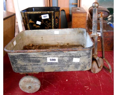 A small vintage tin trolley with remains of original paint with stirrup handle