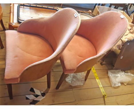 A pair of vintage laminated bentwood barrel back tub chairs upholstered in pink velour, set on moulded square tapered front l
