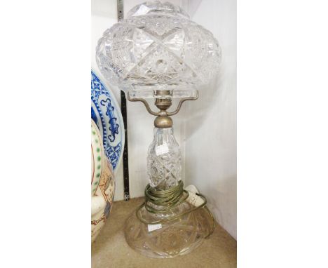 A cut glass table lamp with matching shade