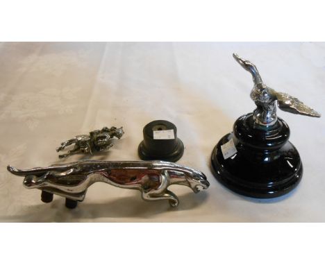 A Jaguar car mascot, eagle mascot on ceramic plinth, and jumping horse and rider mascot