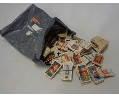 A bag containing a collection of loose cigarette cards, including John Player Uniforms of the Territorial Army and Modern Nav
