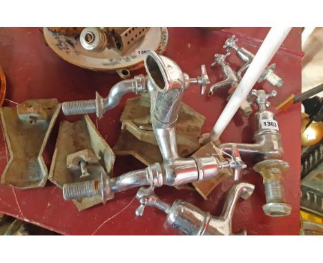 Two pair of vintage chrome plated taps, a large vintage chrome plated shower mixer and a set of four Art Deco cast iron bath 