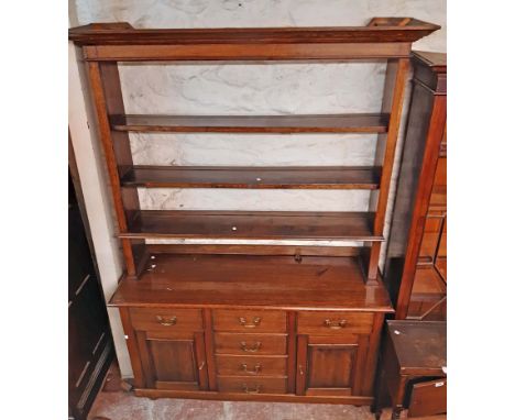 A 1.54m 20th Century polished oak two part dresser with three shelf open plate rack over a base with three frieze drawers, th