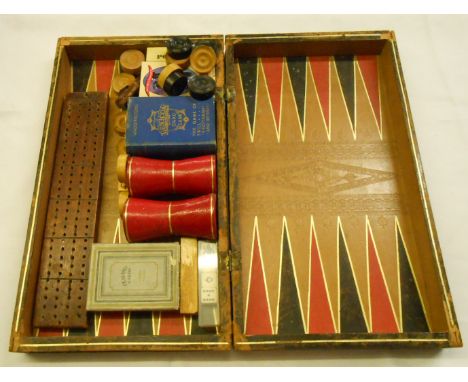A leather clad book form games box containing assorted games including cribbage board, card games, draughts, etc.