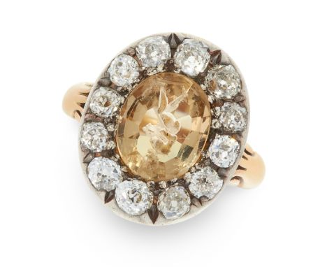 AN ANTIQUE IMPERIAL TOPAZ INTAGLIO AND DIAMOND CLUSTER RING in yellow gold and silver, set with a faceted imperial topaz, the