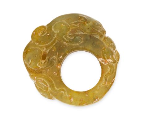 A CARVED JADE RING comprising of a single piece of polished jade, depicting a mythical creature coiled around the circular bo