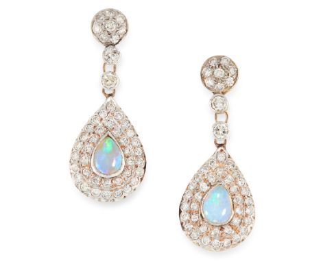 A PAIR OF OPAL AND DIAMOND EARRINGS each set with pear shaped opal cabochon within two halos of round cut diamonds, totalling