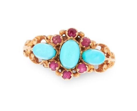 A TURQUOISE AND RUBY RING in yellow gold, set with a central cabochon turquoise in a border of round cut rubies, between two 