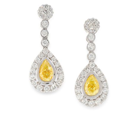 A PAIR OF FANCY YELLOW DIAMOND AND WHITE DIAMOND EARRINGS in 18ct white gold, each set with a pear shaped brilliant cut yello