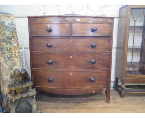 A Victorian mahogany bowfront chest of drawers with ebony stringing, the two short drawers over three long graduated drawers 