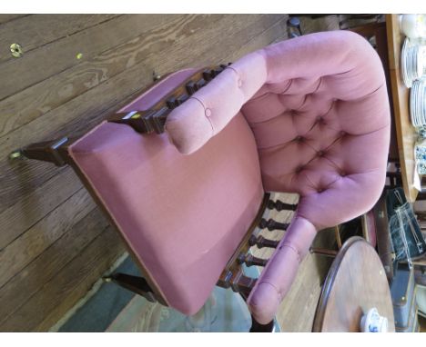 A late Victorian oak tub armchair, the button back on reeded square tapering supports on brass castors
