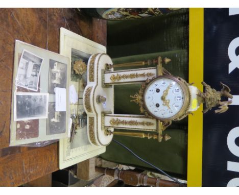 A 19th century French alabaster and giltmetal mantel clock, the drum case surmounted by birds, on foliate applied supports an