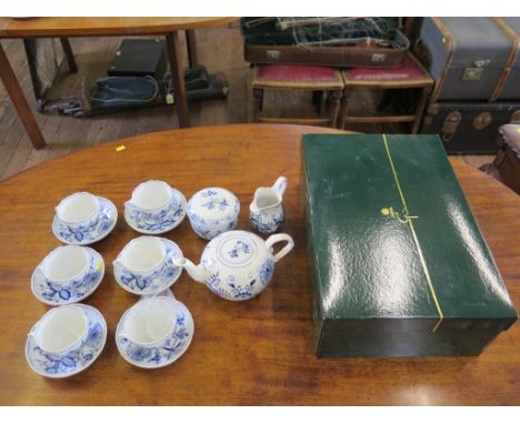 A Meissen blue and white tea service, with six cups and saucers, sugar bowl, milk jug and teapot, in a Thomas Goode presentat