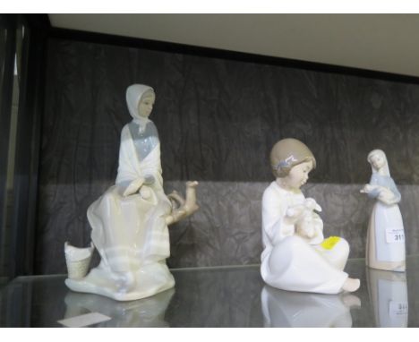 Lladro and Nao figures, including girl feeding a lamb, lady watching a bird (lacks bird) and other child figures (5)