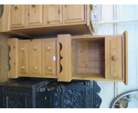 A pine chest of two short and three long drawers on bracket feet, 91.5cm wide and two pine bedside cupboards (3)