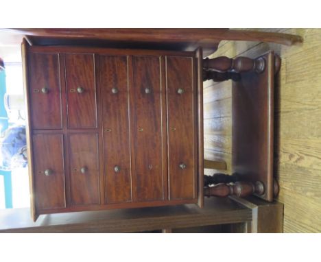 A small mahogany chest of drawers with four short and three long drawers, on turned legs, shelf and pad feet, 53cm wide 28cm 