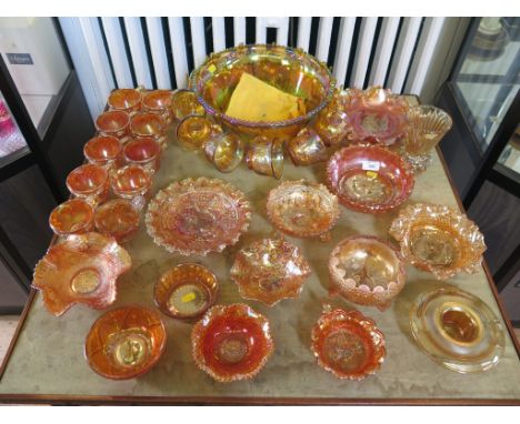 A collection of carnival glass, all amber with lustre finish including punch bowl and twelve cups, ten further cups and dishe