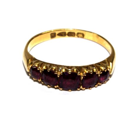 A five stone ruby ring set in 18 carat gold