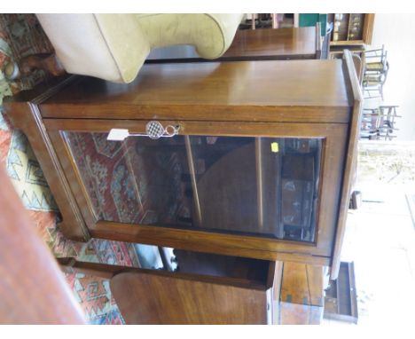 A stained beech display cabinet, with single glazed door on bracket feet and castors, 53cm wide 93cm high