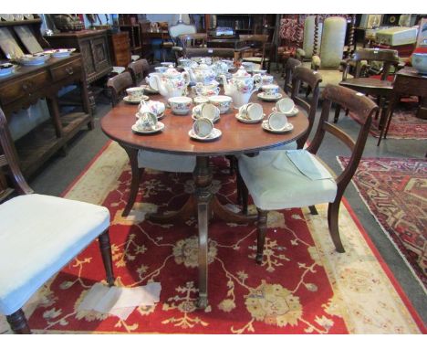 A mahogany D-end dining table on tripod bases to brass claw castor feet, with extra feet