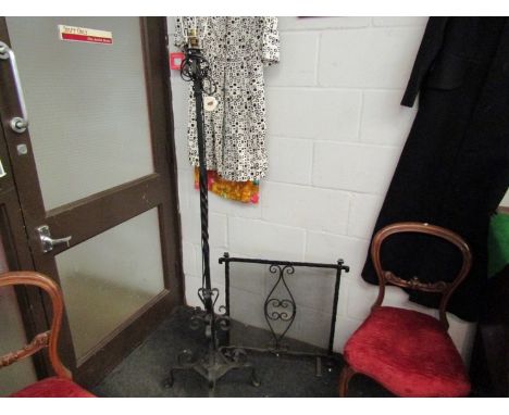 A black wrought iron standard lamp and firescreen