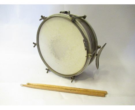 A vintage steel shell marching snare drum and sticks