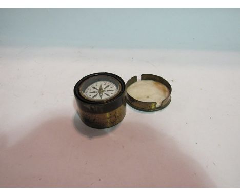 A brass cased pocket compass on gimbal