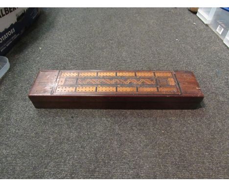 A cribbage board and dominoes