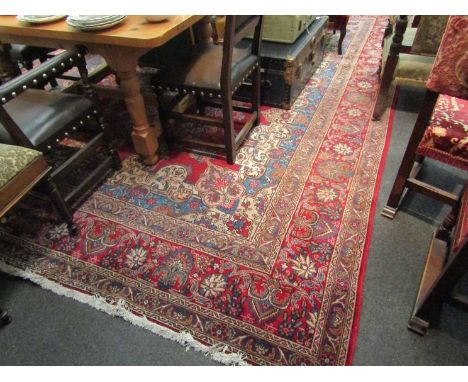 A Tabriz carpet in reds and blues with floral border, 422cm x 311cm