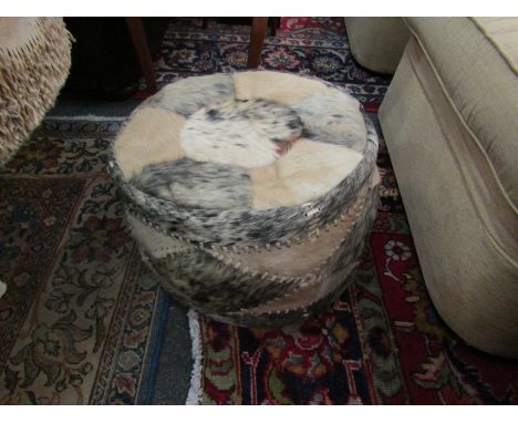 A cowhide pouffe