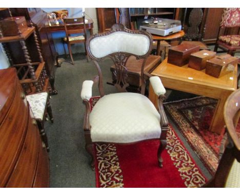 Circa 1890 a mahogany armchair with carved shell crest and acanthus leaf pierced backrest over cabriole legs and ceramic cast