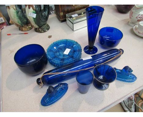 Two Bristol blue coloured glass finger bowls. A similar rolling pin and beaker, lions etc.