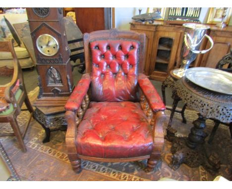 A pair of Victorian red leather button library armchairs