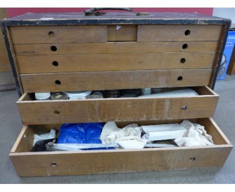 A wooden engineer's cabinet, with tools