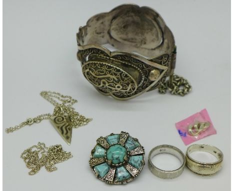 Two silver rings, a white metal Persian bangle, a silver pendant and chain and a brooch
