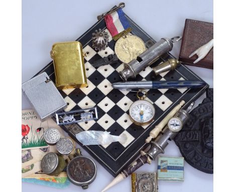 An ebony and ivory travelling games board, 1836 love token, a whistle with compass, a Thorens pocket lighter, perfume cards e