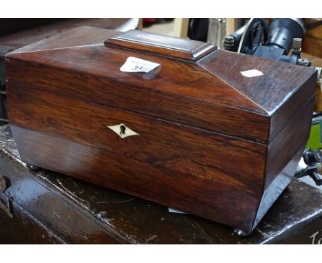 A 19th century rosewood sarcophagus tea caddy with inlaid shell motif 
