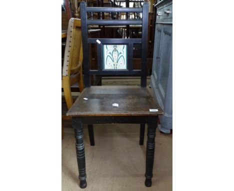 A Victorian Art Nouveau ebonised hall chair with tile back, on turned legs 