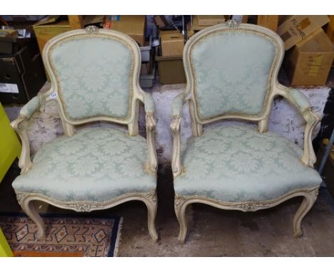 A pair of cream painted and light green upholstered open-arm bedroom chairs, on cabriole legs 