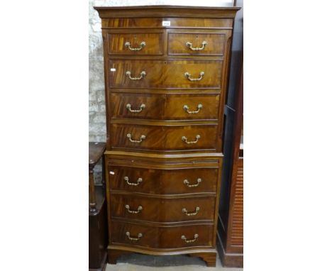 A reproduction mahogany serpentine-front chest on chest of 2 parts, with 8 cross-banded fronted drawers on bracket feet, W71c