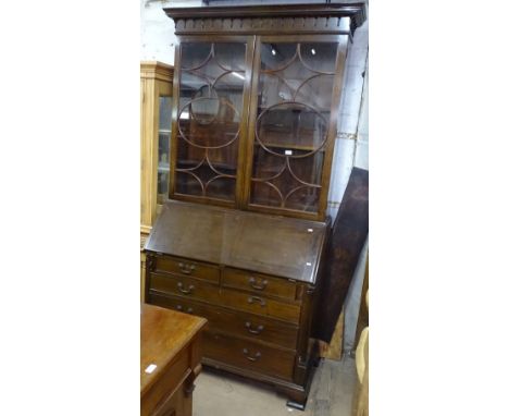 A good quality reproduction mahogany bureau bookcase, the top having lattice glazed doors, with adjustable shelves above a st